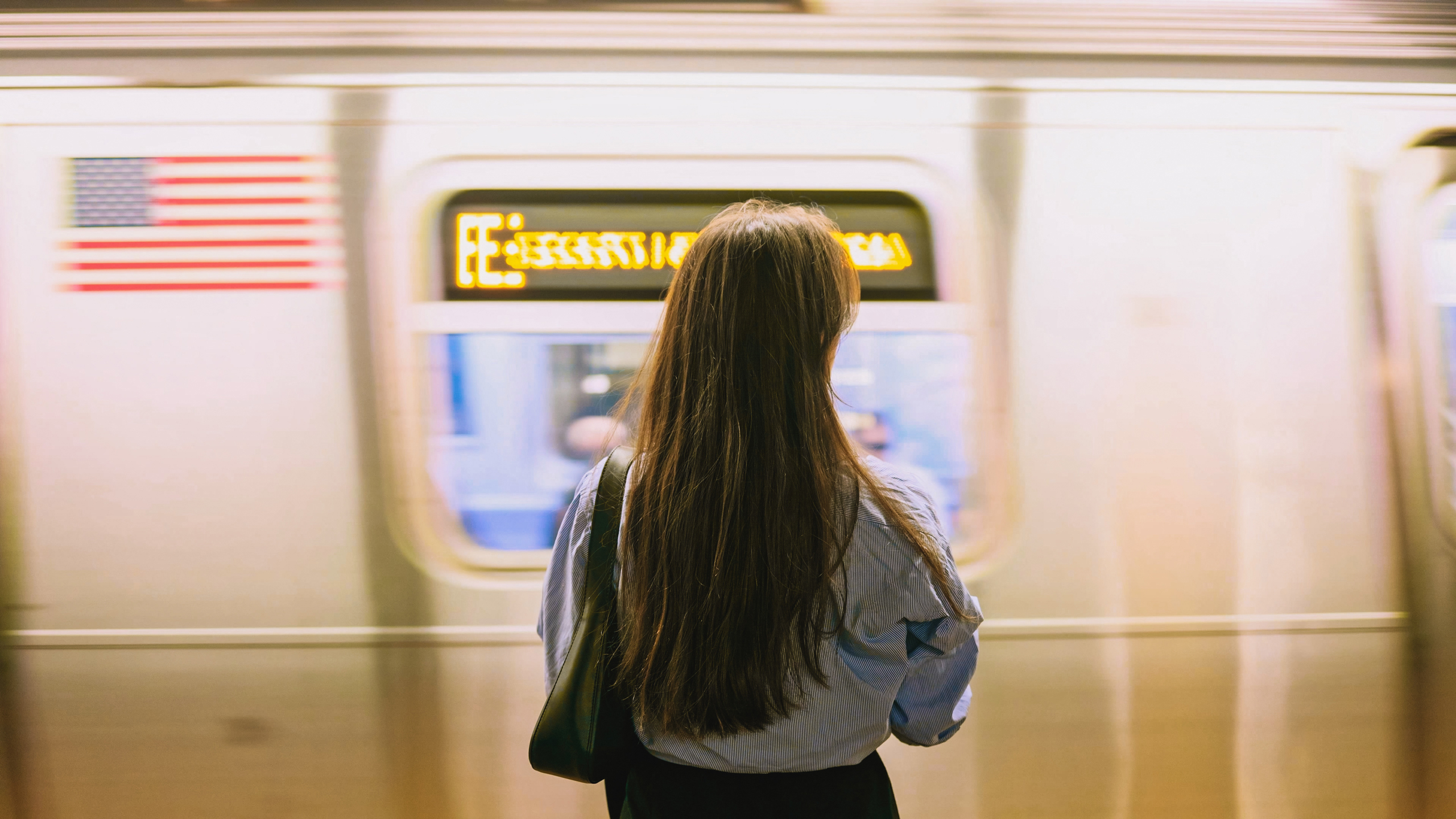 A woman waiting for a subway train.